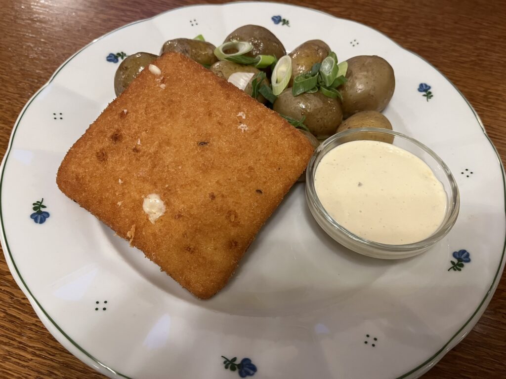 A dish of fried cheese and potatoes.