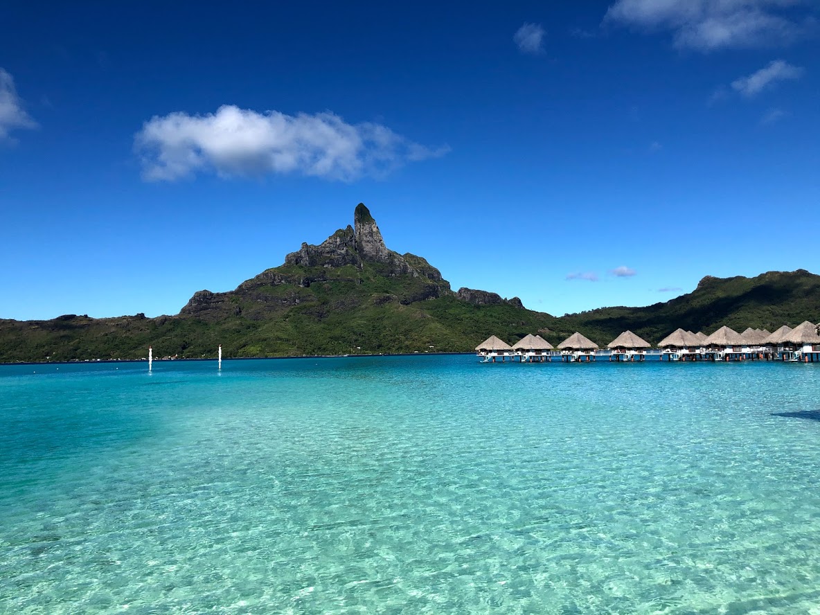 mountain, blue water, overwater bungalows