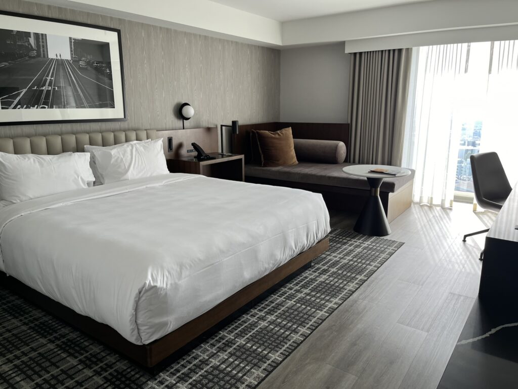 A hotel room with a king bed and couch