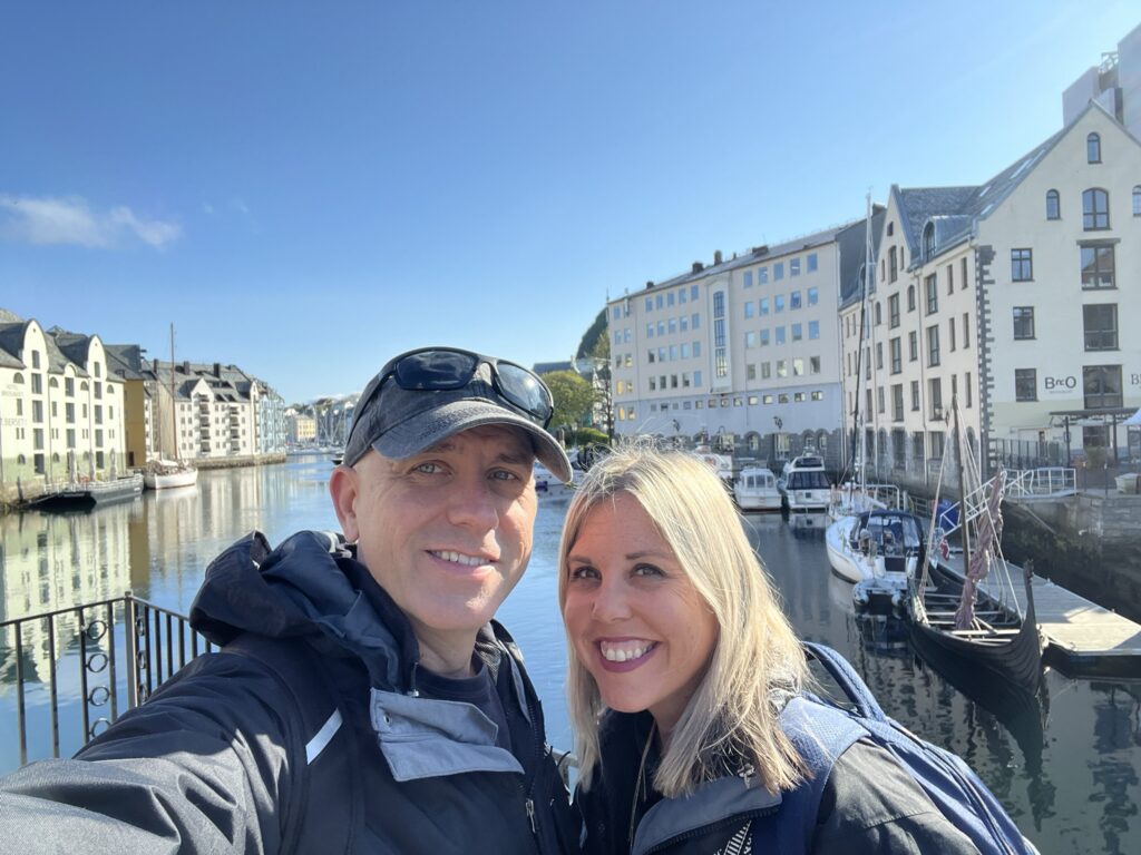 two people in front of the harbor in Alesund